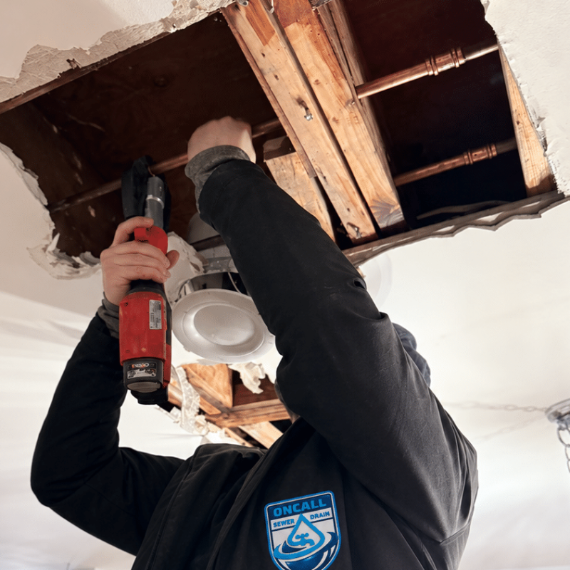 oncall technician fixing a leak in the ceiling
